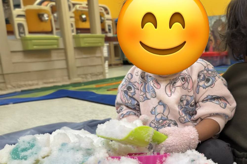 Baby playing in a foam sensory bin