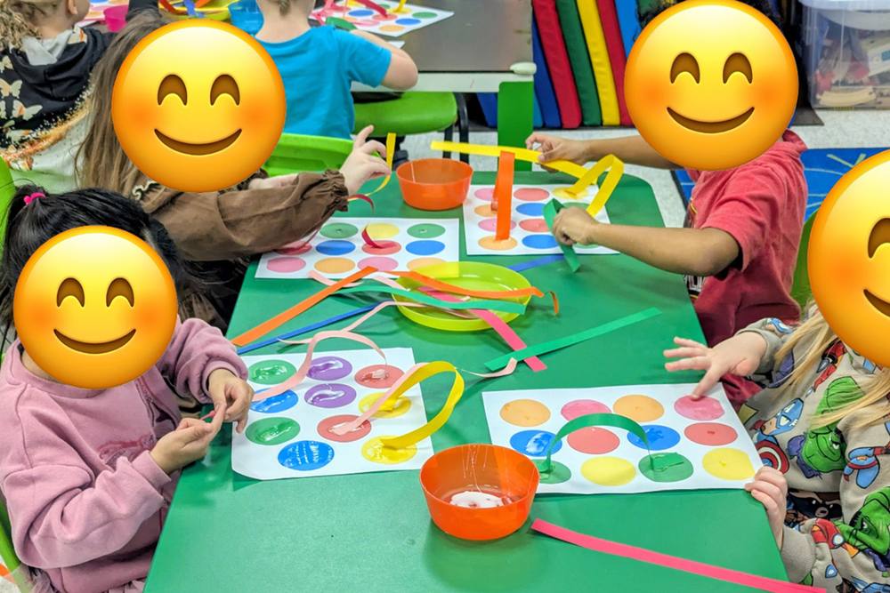 Preschoolers matching coloured ribbons to painted dots