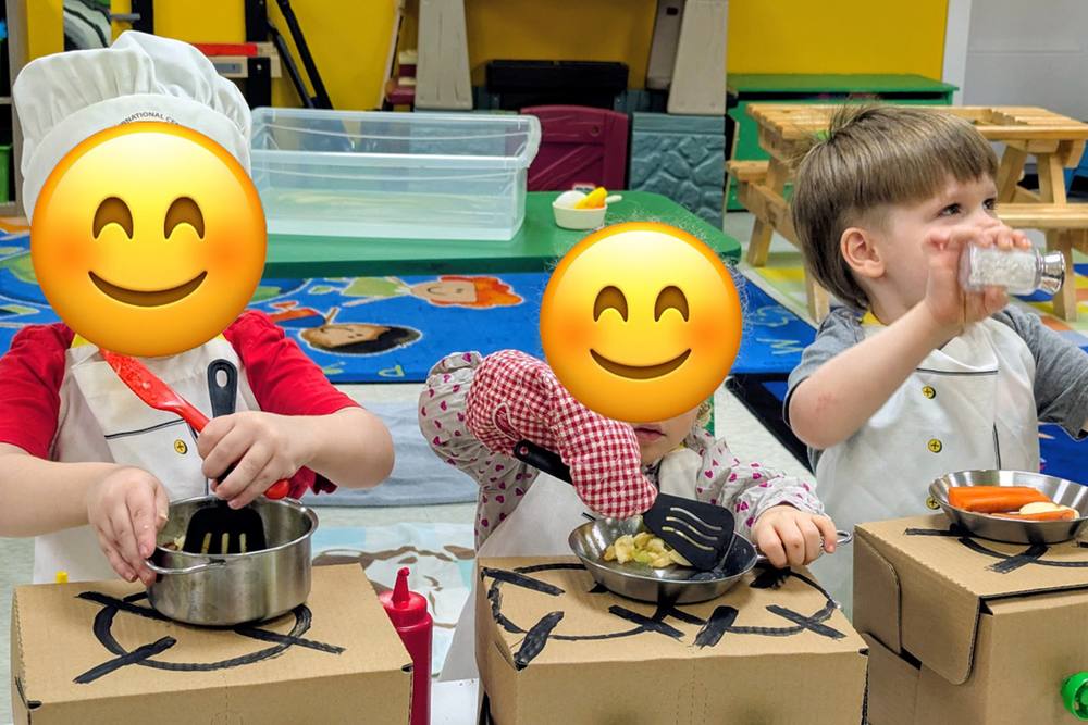 Preschoolers in chef hats cooking in pretend play