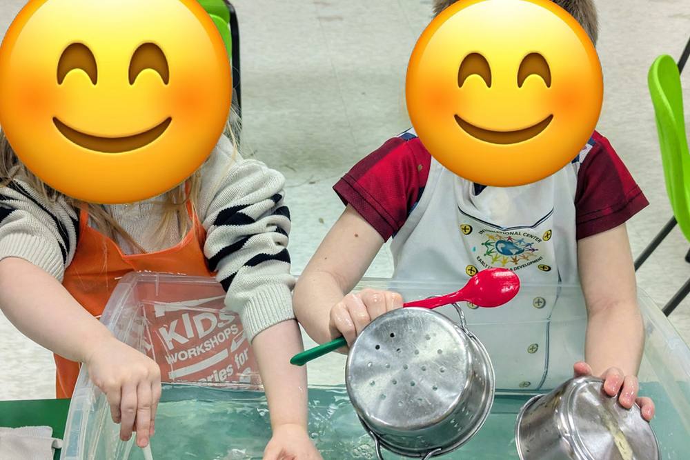 Preschoolers pouring water with kitchen utensils